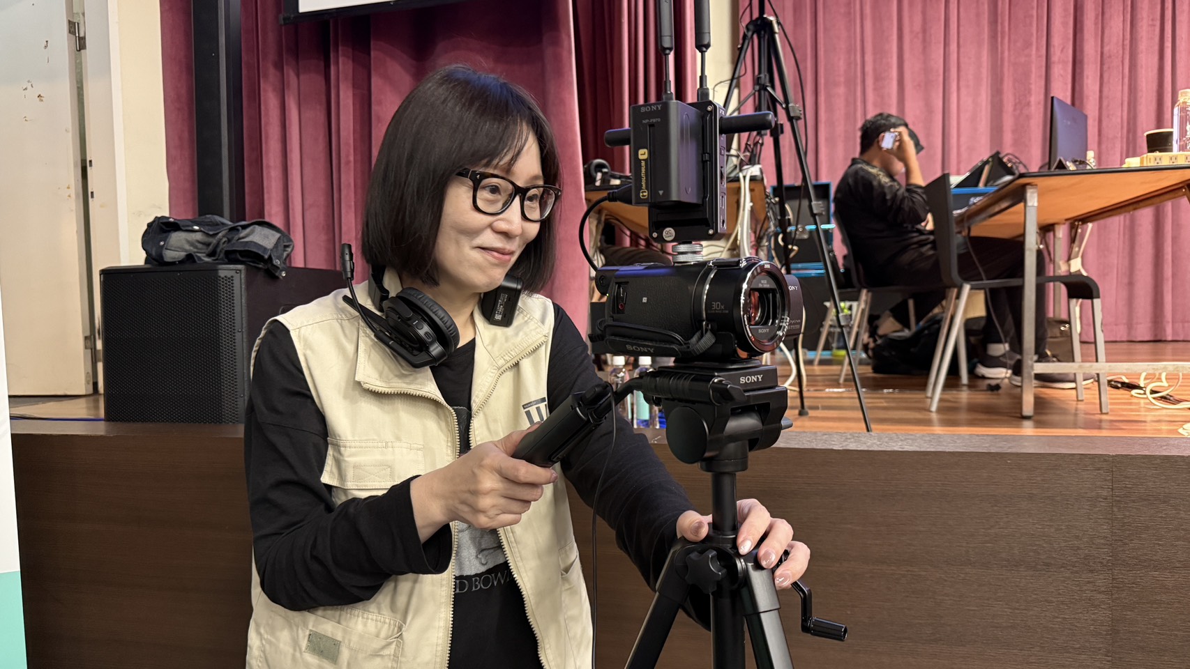 A bright pink sheet of paper used to wrap flowers curves in front of rich blue background